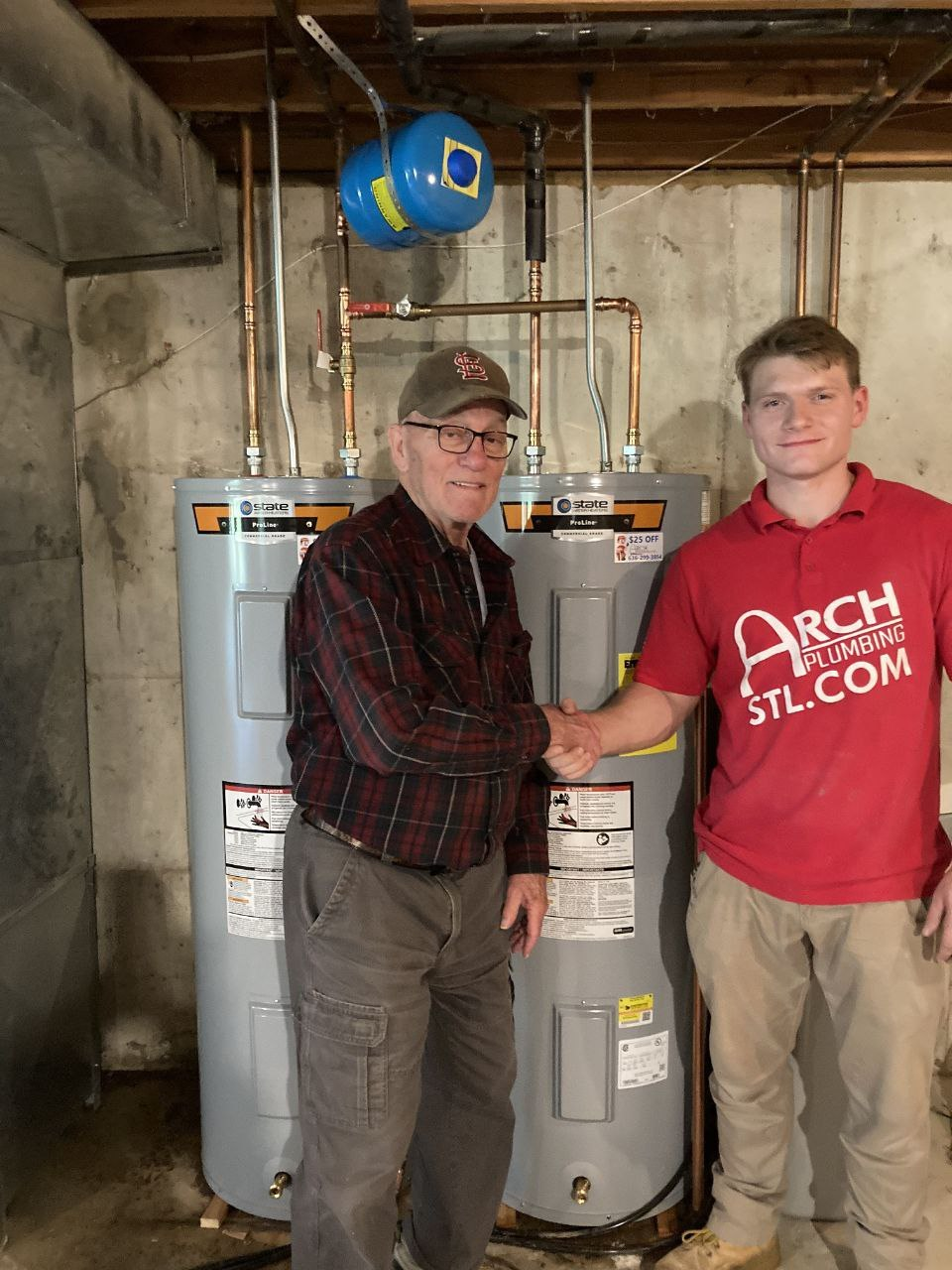 Plumbing technician shaking hands with a happy homeowner after a same-week install